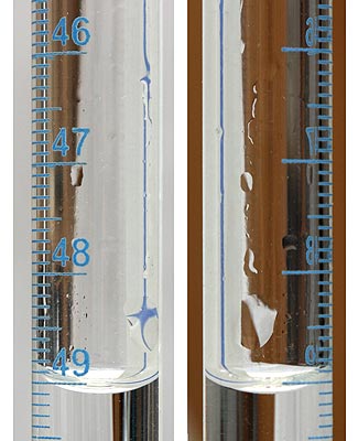 droplets of the reagent solution on the surface of the greasy glass